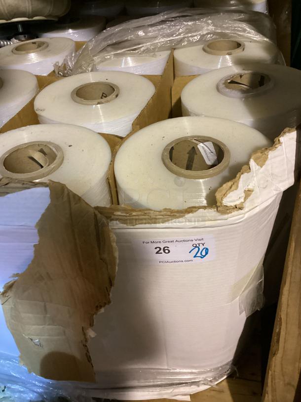 Pallet of 20 shrink wrap rolls, each in good condition. Visible auction tag notes quantity and website link.