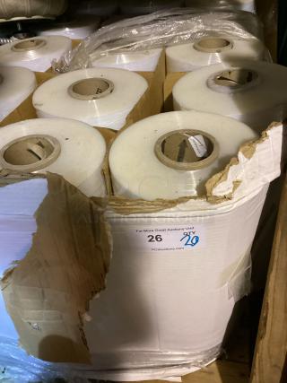 Pallet of 20 shrink wrap rolls, each in good condition. Visible auction tag notes quantity and website link.