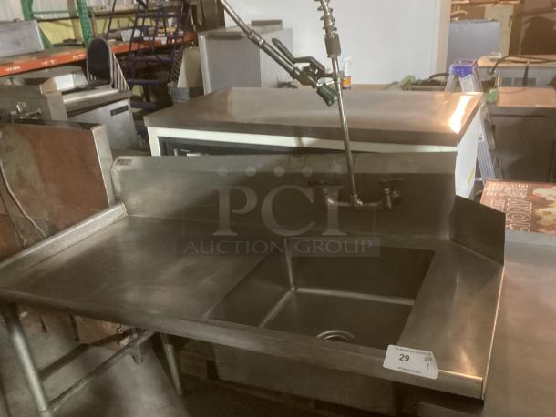 Stainless steel wash sink runner, 60x31x45 inches, features a deep basin and dual faucet. Industrial condition, item tag visible.