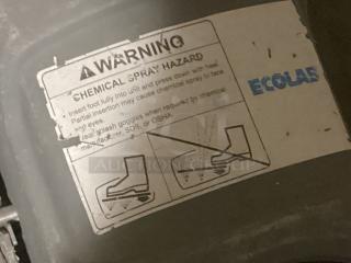 Eco Lab foot scrubber label displaying chemical spray hazard warning and instructions for safe use.