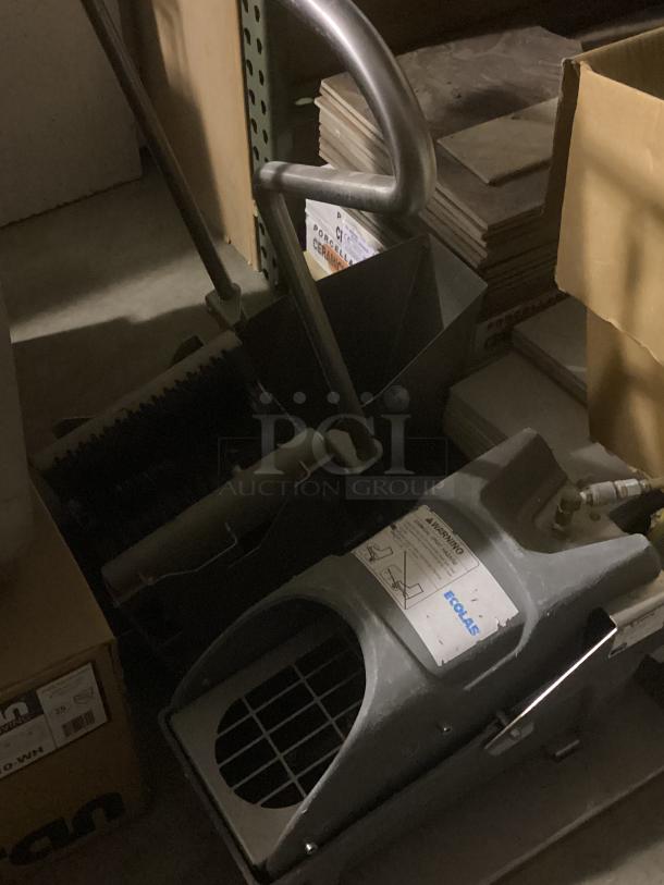 Eco Lab Foot Scrubbers in storage. Features a sturdy metal handle and industrial design. Labeled with Eco Lab branding.