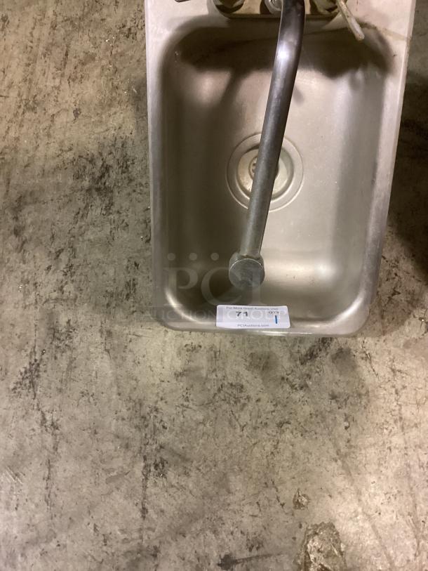Stainless steel hand sink with faucet, 12x18 inches, includes visible label with auction details. Good condition.
