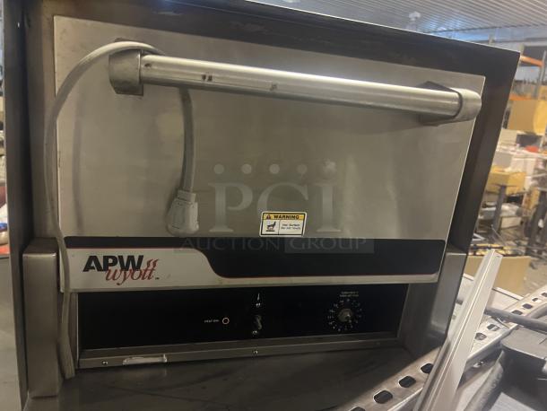 APW Wyott CD0-17 electric pizza deck oven, stainless steel, 22"x22.5"x17.5", temperature dial, power cord visible.