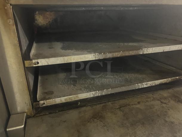 APW Wyott CD0-17 countertop electric pizza deck oven in used condition, showing metallic interior with visible wear.