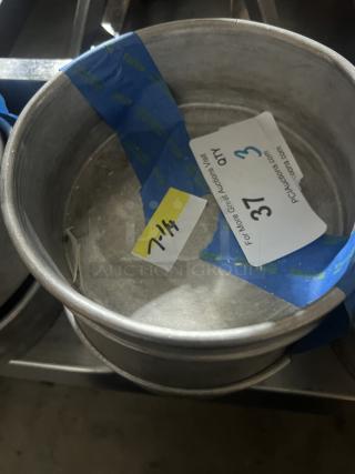Set of three 7-1/4" cake pans in used condition, marked with auction label indicating quantity and lot number.