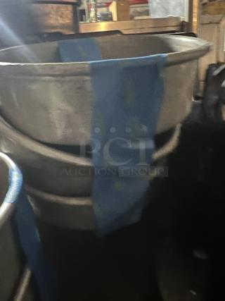 Set of three 7-1/4” metal cake pans, stacked, with blue tape markings, in used condition.