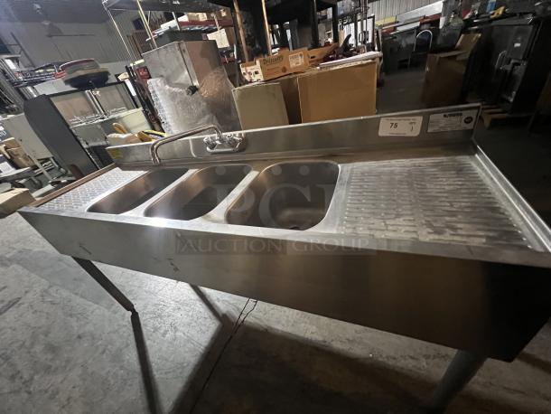 Krowne stainless steel underbar sink, model 18-53c, featuring three basins and a drainboard. Dimensions 77 x 31 x 83.