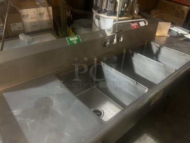Stainless steel 3-bay dish sink with faucet and nozzle, 92x31x44 inches, labeled wash, rinse, sanitize, in good condition.