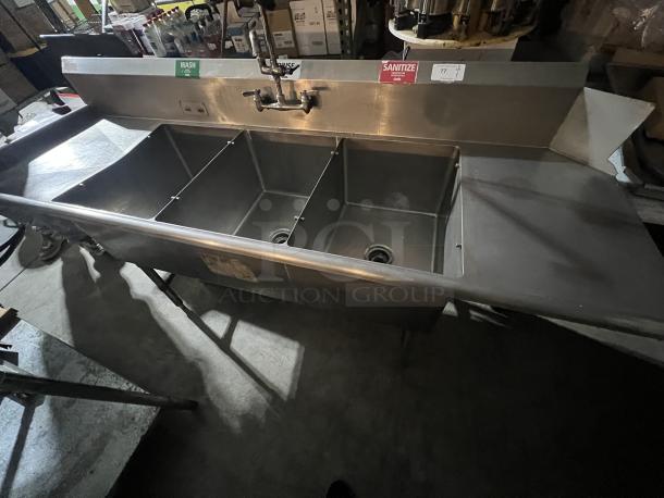 Stainless steel 3-bay dish sink with faucet and nozzle, 92"x31"x44", labeled "WASH" and "SANITIZE," in used condition.