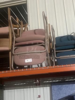 Two office chairs, pink upholstery, metal frames, stacked. Label indicates quantity of 2, item 80. Good used condition.