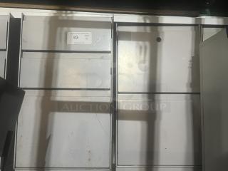 Four gray cubicle-style filing cabinets in used condition, auction tag indicating quantity 4.
