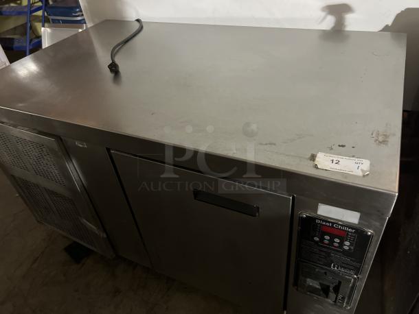 Stainless steel blast chiller, 56x34x33 inches, not tested, visible control panel and auction label, minor wear.