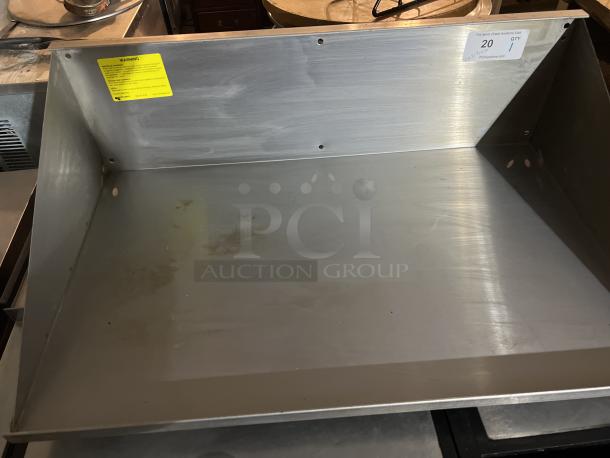 Stainless steel wall mount shelf, 34x21-½x10 inches. Visible wear and light stains. Includes yellow warning label and auction tag.