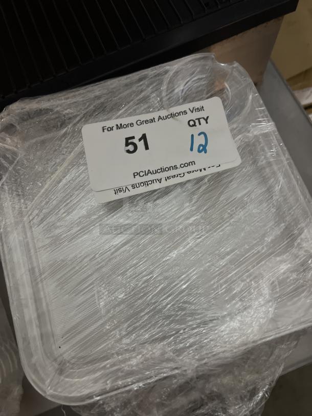 12 appetizer/snack trays with wine glass holders, wrapped in plastic, marked with label "51" indicating auction lot.