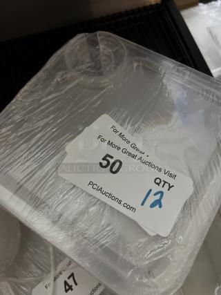 Set of 12 appetizer trays with wine glass holders, wrapped in plastic. Auction tag indicates "QTY 12."