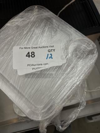Set of 12 appetizer trays with wine glass holders, wrapped in plastic. Tag shows "Qty 12" from PCIAuctions.com.