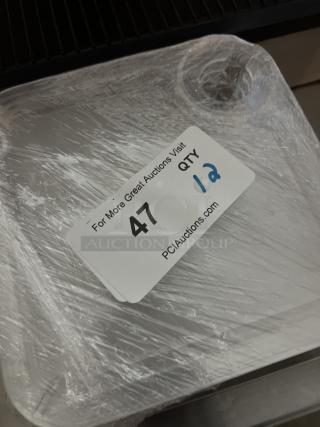 Appetizer trays with wine glass holder, set of 12, wrapped in plastic. Auction label indicates "QTY 12", visit "PCIAuctions.com".