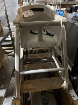 Grey plastic high chair with harness, scuff marks visible. Auction tag labeled "61, qty 1." Used condition.
