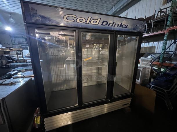 True 3-Door Refrigerated Cooler, 78x30x79-½, features glass doors, Cold Drinks signage, shown in warehouse, good condition.