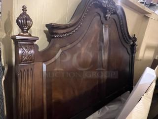 Heavy king-sized headboard with carved wood details, ornate posts, and elegant finishing. In good condition.
