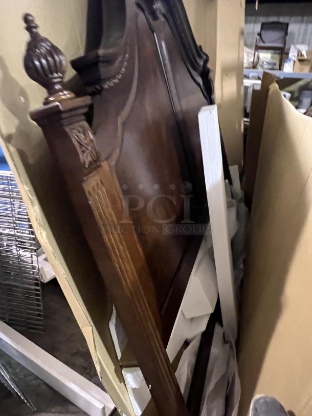 Heavy king-sized headboard with ornate wood carvings, dark finish, and classic design; good condition, ideal for elegant decor.