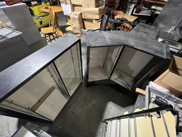 Black 2-piece merchandise display, corner design, adjustable shelving, used condition, ideal for retail environments.