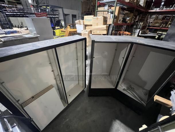 Black 2-piece merchandise display, open shelving, good condition, sturdy construction, ideal for retail use.