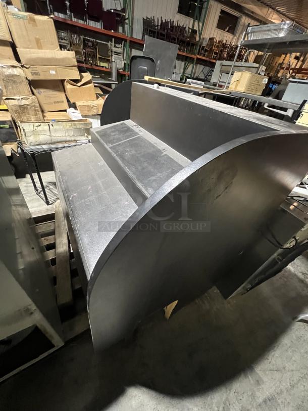 Black 2-piece merchandise display featuring curved sides, tiered shelves, and sturdy construction. Suitable for retail use.