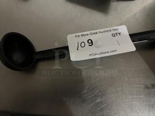 Black plastic ladle in good condition with auction tag numbered 109 on handle.