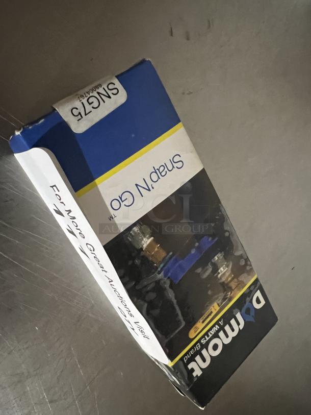 Snap and Go Gas Line Holder in original packaging, labeled SN675, Domon brand, unopened, suitable for secure gas line management.