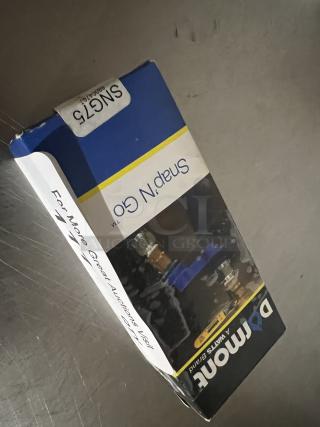 Snap and Go Gas Line Holder in original packaging, labeled SN675, Domon brand, unopened, suitable for secure gas line management.