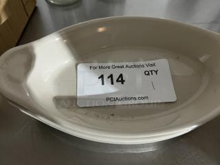 Cream-colored oval au gratin dish in good condition with slight markings. Label reads "114 QTY, PCIAuctions.com."