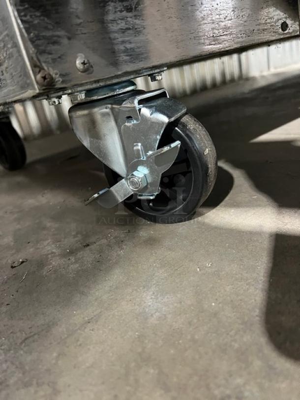 Close-up of a caster wheel on a Blue Air BDD59-2B beer dispenser. Features sturdy construction for mobility.