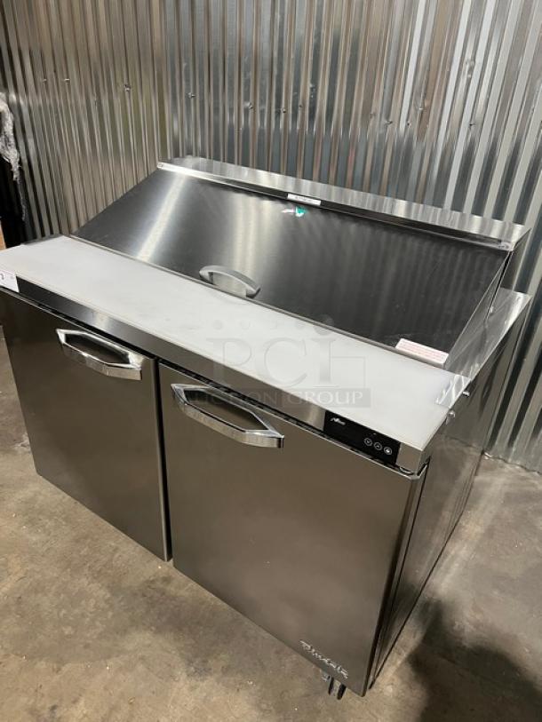 Blue Air BLPT48HC 2-door refrigerated prep table, stainless steel, with cutting board and food pan, new condition on casters.