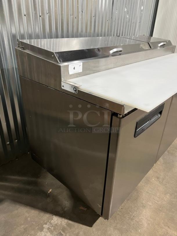 Blue Air BAPP67 stainless steel 2-door refrigerated pizza prep table, bain marie style, with cutting board and food pan, on casters.