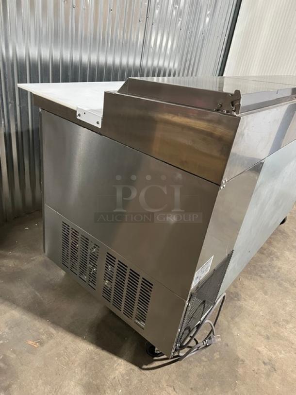 Brand new Blue Air BAPP67 pizza prep table, stainless steel, 67", with cutting board, food pan, wired rack, on casters.