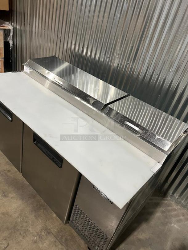 Brand new Blue Air 67" stainless steel 2-door pizza prep table, model BAPP67, with cutting board, food pan, and rack.