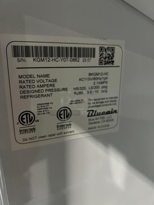 Label on Blue Air BKGM12HC refrigerator showing model details: 115V, 1 phase, R290 refrigerant, SN: KGM12-HC-Y07-0862.