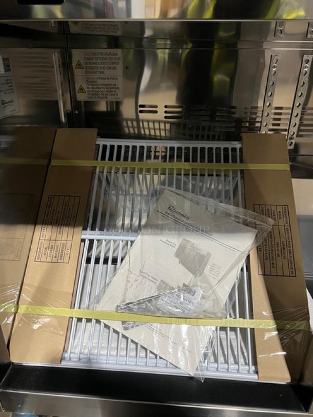 Brand new Blue Air BLMT48HC refrigerated prep table, features stainless steel design, cutting board, poly rack, and food pan.