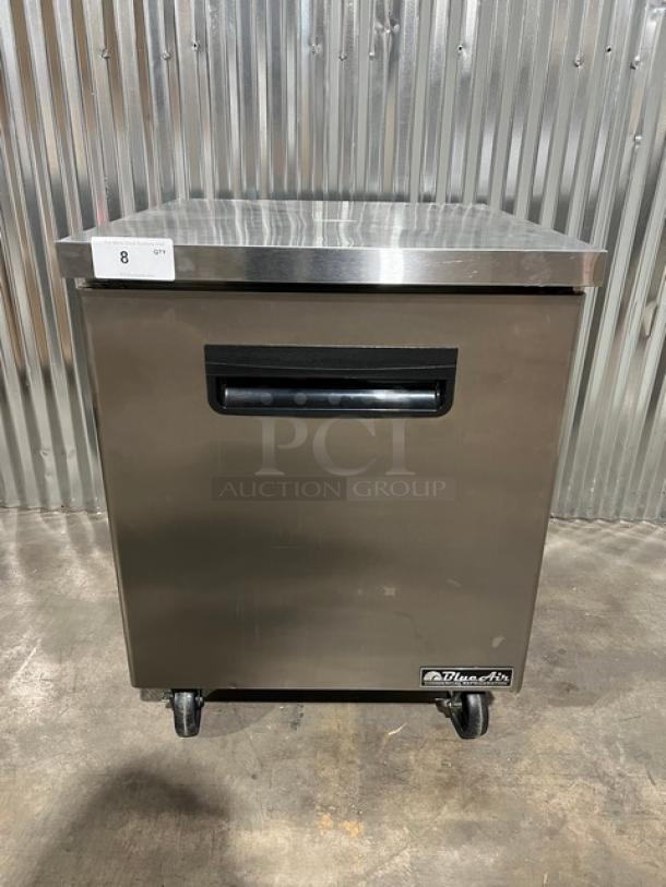 Brand new Blue Air stainless steel single door undercounter refrigerator, model BAUR28, on casters, with poly-coated rack.