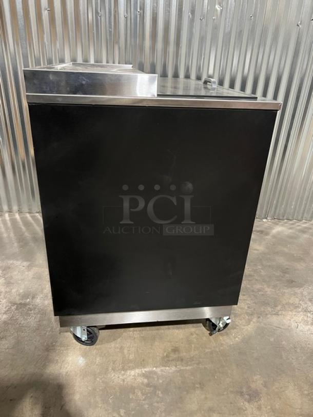 Brand new Blue Air BGF36B black 36" glass froster/bottle cooler with stainless steel worktop, slide-back lid, and casters.