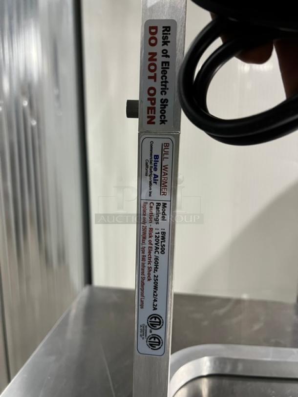 Blue Air BWL500 Bull-Warmer Series stainless steel heat lamp with dual shatter-proof bulbs, new condition, 120V, labeled for safety.