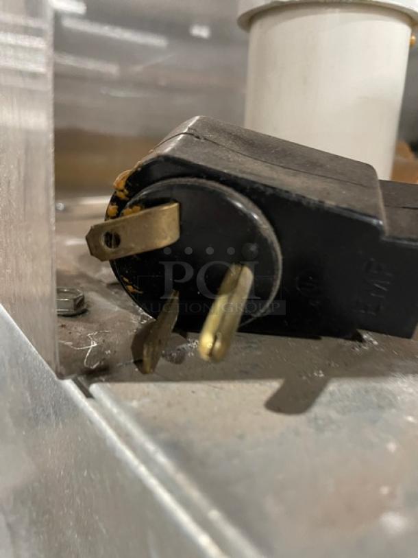 Close-up of power plug and cord of Master-Bilt IHC-48 ice cream cabinet. Plug shows standard prongs for 115/208-230V.