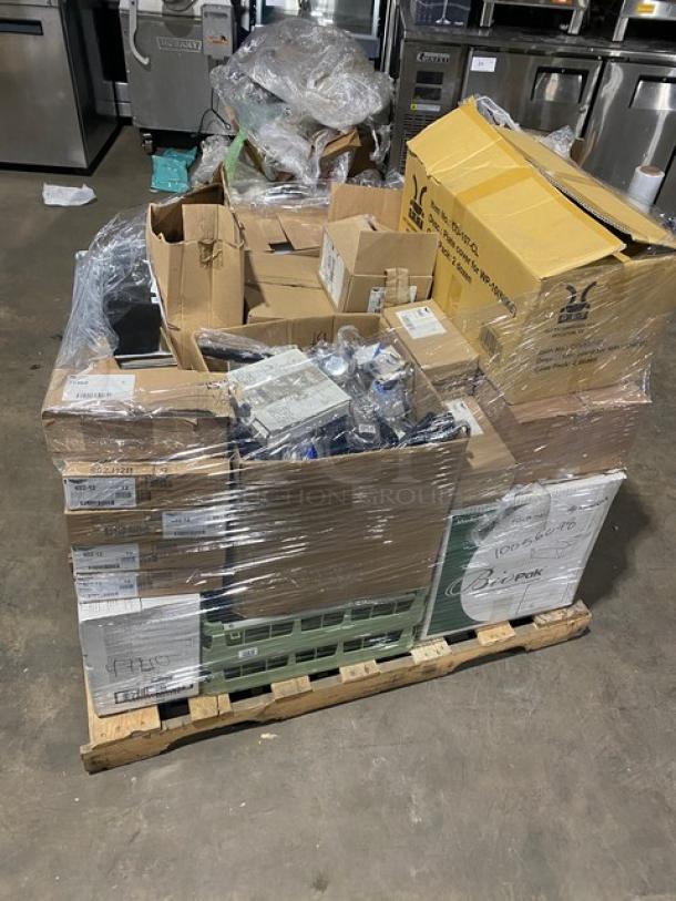 Mixed pallet of brand-new commercial kitchen items on a pallet, including G.E.T. plate covers and Vollrath products.