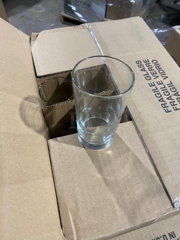 Mixed pallet of brand new Libbey commercial glassware, including customizable 12 oz. stemmed pilsner glasses, in original packaging.