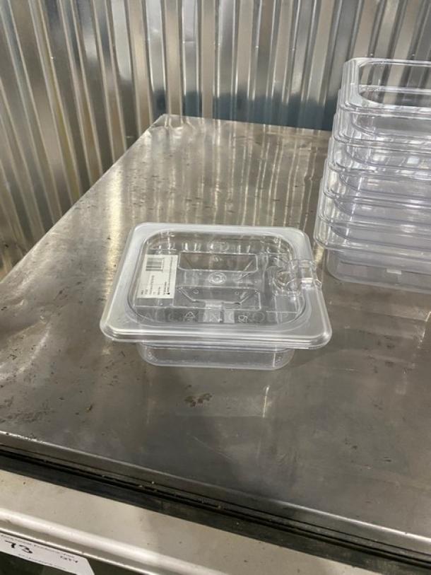 Brand new Winco SP7602/SP7500C clear polycarbonate 1/6-size food pan, 2.5" deep, with slotted lid, barcode label visible.