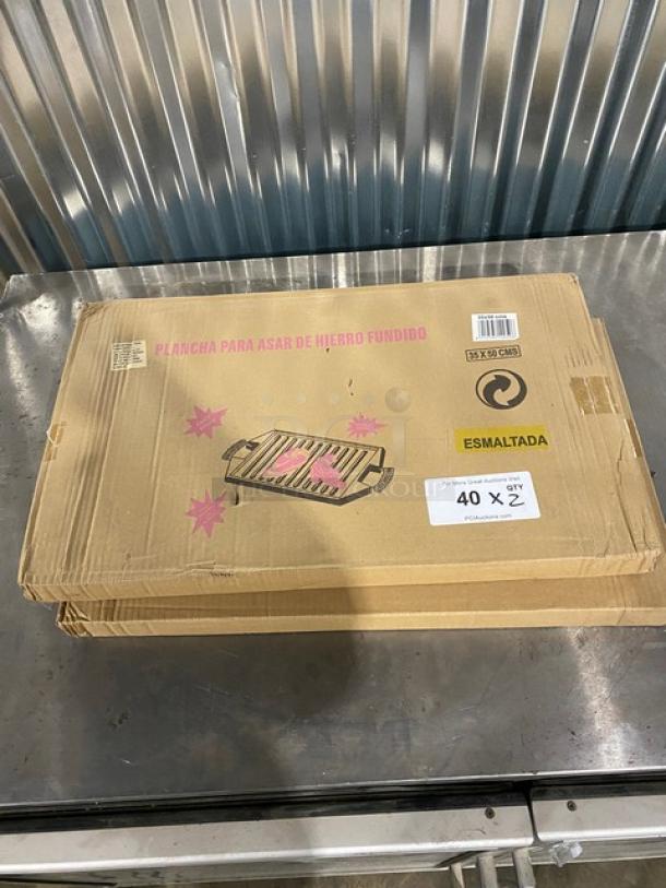Brand new Guison 35cmx50cm black enamelled cast iron plancha griddle in box. Box marked with item info and "esmalada".