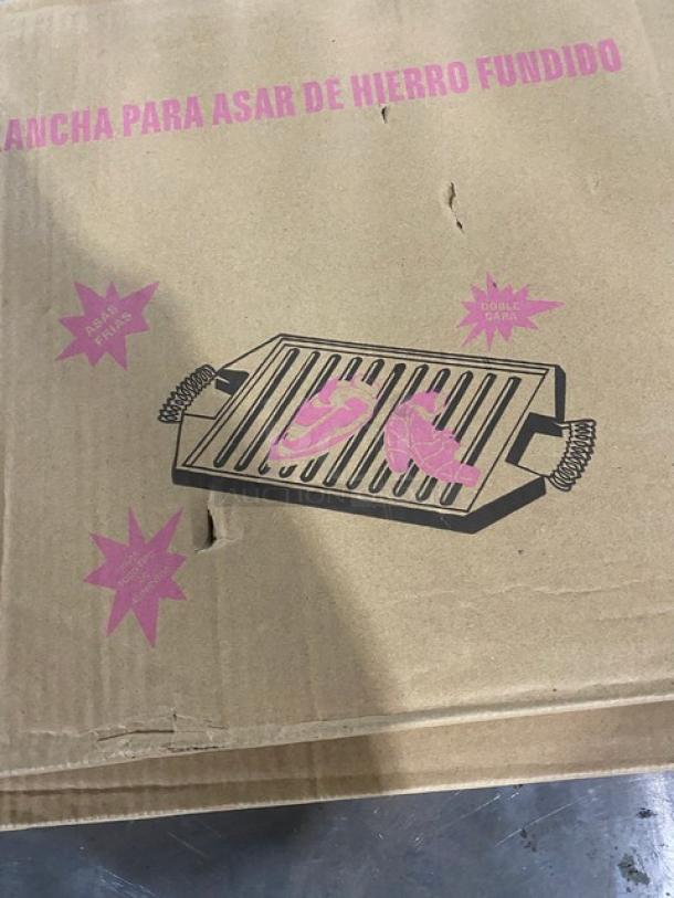 Brand new Guison cast iron griddle, 35cmx50cm. Black enamel, commercial cooktop plancha. Box shows griddle illustration.