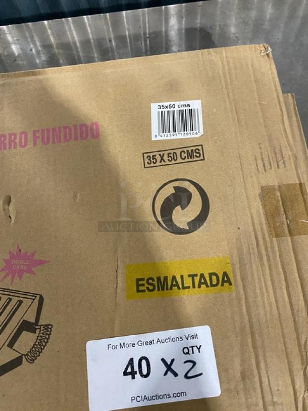 Brand new Guison black enamelled cast iron plancha griddle, 35x50cm, rectangular, in original packaging with product details.