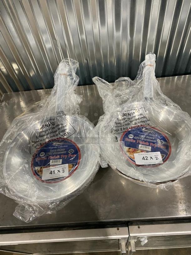 Brand new Winco Winware Majestic Collection 14" aluminum fry pans, Model AFP-14S, in original packaging with labels.